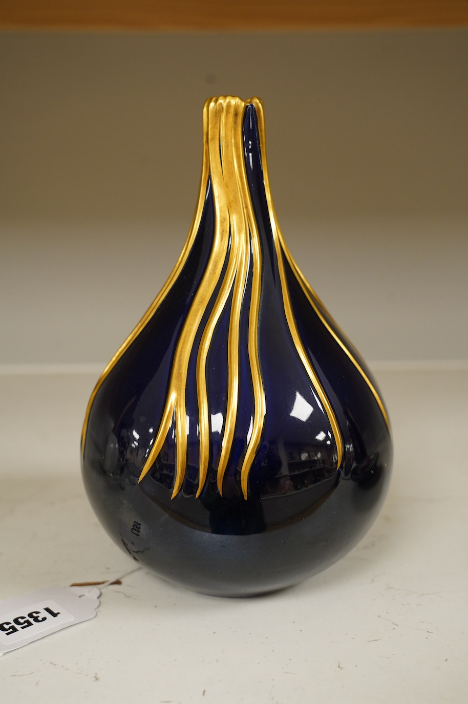 Richard Ginori cobalt blue and gilt bottle vase, mid century, designed by Giovanni Gariboldi, with raised streams of gold running down from the top, numbered 1913E, 21.5cm high. Condition - good